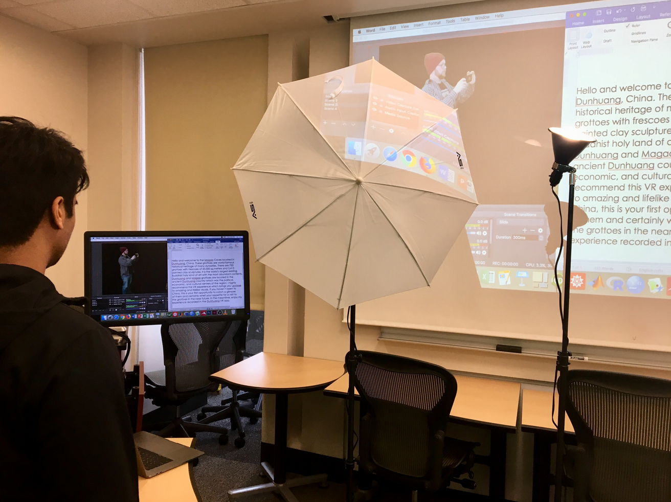 A LEDS assistant prepares lighting and visual resources for a presentation.